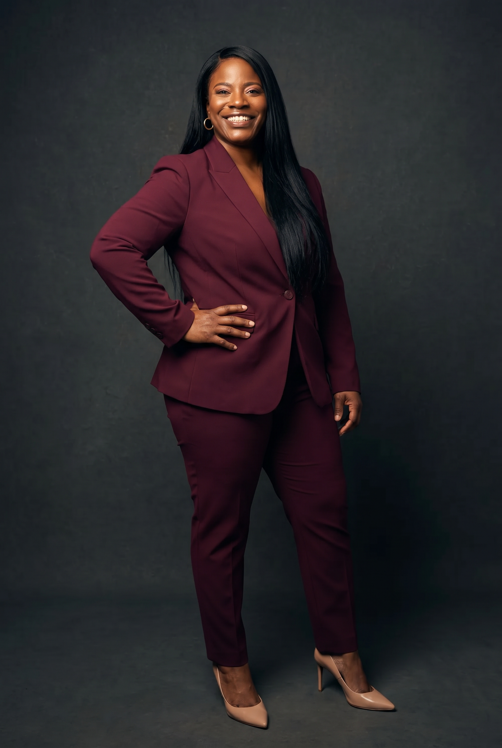 Dr. Pamela Buchanan in a burgundy power suit on stage